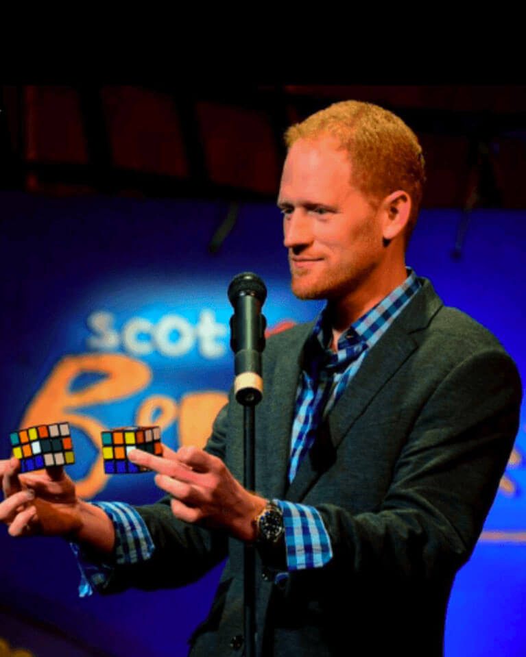 magician holding rubix cube